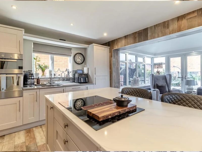 The impressive open plan kitchen/diner features a range of modern shaker and high gloss cabinets with contrasting quartz work surfaces. There are a range of integrated appliances to include a stainless steel single oven and separate grill oven, microwave, induction hob with built-in down drought extractor, fridge/freezer, wine cooler and dishwasher. There is a substantial central island which can accommodate seating for 6 people with three ceiling light points above.