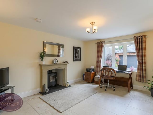The last of the ground-floor spaces to check out at the £700,000 property is this versatile sitting room, complete with solid stone feature fireplace and multi-fuel stove. The porcelain tiled floor and underfloor heating extend to here too.,