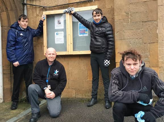 Thomas Bates, Simon Dosanjh, Nathan Buckingham and Ethan Poole with the new noticeboard they made for Holy Trinity Church in Shirebrook.
