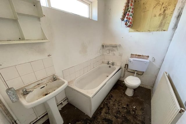 The ground floor of the terraced house also contains this bathroom. It comprises a bath, pedestal wash hand basin, low-level WC and window to the side of the property.