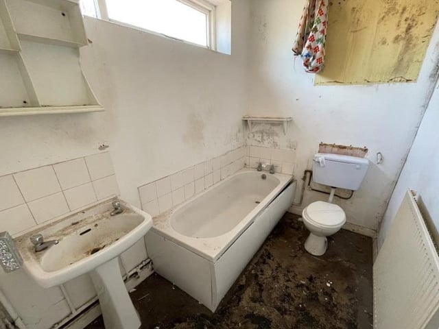 The ground floor of the terraced house also contains this bathroom. It comprises a bath, pedestal wash hand basin, low-level WC and window to the side of the property.