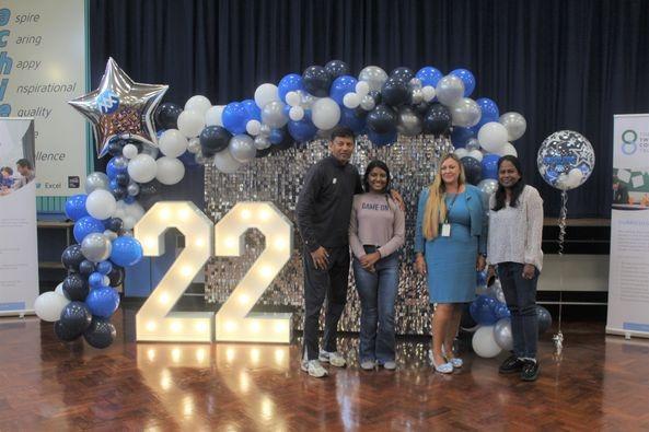 Binaya Dharmapala who got three grade 9’s, four grade 8’s, one grade 6 and one grade 5, with her parents and headteacher, Katrina Kerry