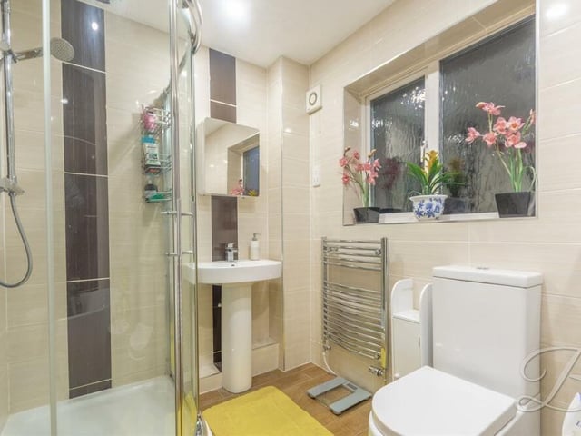 The family bathroom comprises a modern four-piece suite. As well as the bath, there is a walk-in shower cubicle, low-flush WC, vanity hand wash basin, full-height tiling and a chrome, heated towel-rail.
