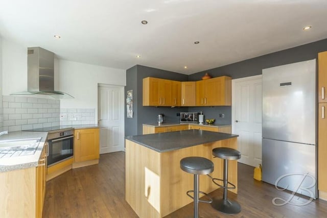 On now to the contemporary kitchen, which can be regarded as the hub of the home. It is fitted with shaker-style cabinets and units, complementary worktops and a range of integrated appliances, including an oven.