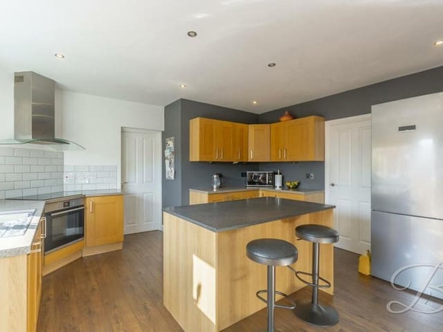 On now to the contemporary kitchen, which can be regarded as the hub of the home. It is fitted with shaker-style cabinets and units, complementary worktops and a range of integrated appliances, including an oven.