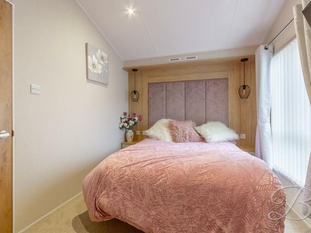 The master bedroom features built-in wardrobes and also access to a private en suite.