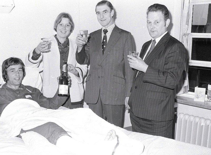 Barry Foster celebrates promotion in his hospital bed after breaking his leg in 1977.