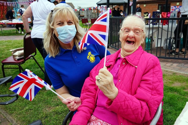Lynda Etchells and Shirley Gascoigne waving their Union Jacks for the Queen at The Oaklands complex in Warsop.