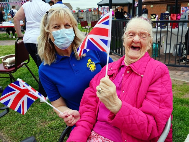 Lynda Etchells and Shirley Gascoigne waving their Union Jacks for the Queen at The Oaklands complex in Warsop.