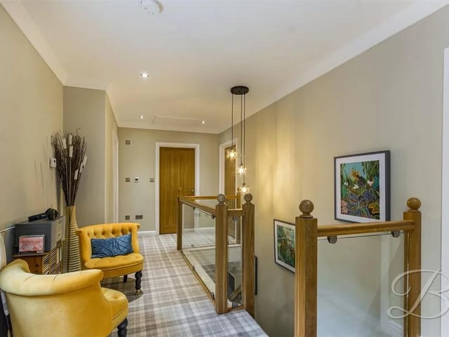 With carpeted flooring, central heating radiator, downlights, glass balustrade, coving, window to the front elevation