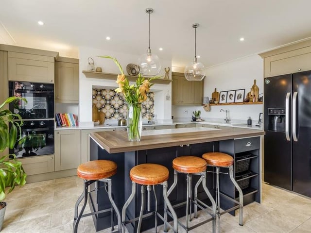 Integrated appliances within the kitchen include two electric ovens.