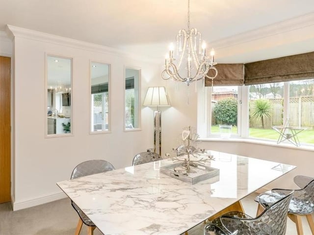 The dining room has a three-glass feature that looks through to the dining kitchen. There is also coving to the ceiling.