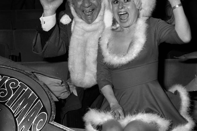 Carry On stars Sid James and Barbara Windsor welcoming guests to a party for ITV's Christmas performers at the New London Theatre in 1973.