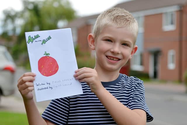 Jacob Collier holding his book he has written and illustrated during the coronavirus lockdown.