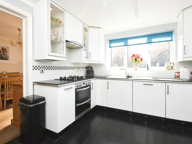 Moving on now to the modern, fitted kitchen, which is next to the dining room. Light and airy, it features stacks of cupboard and storage space.