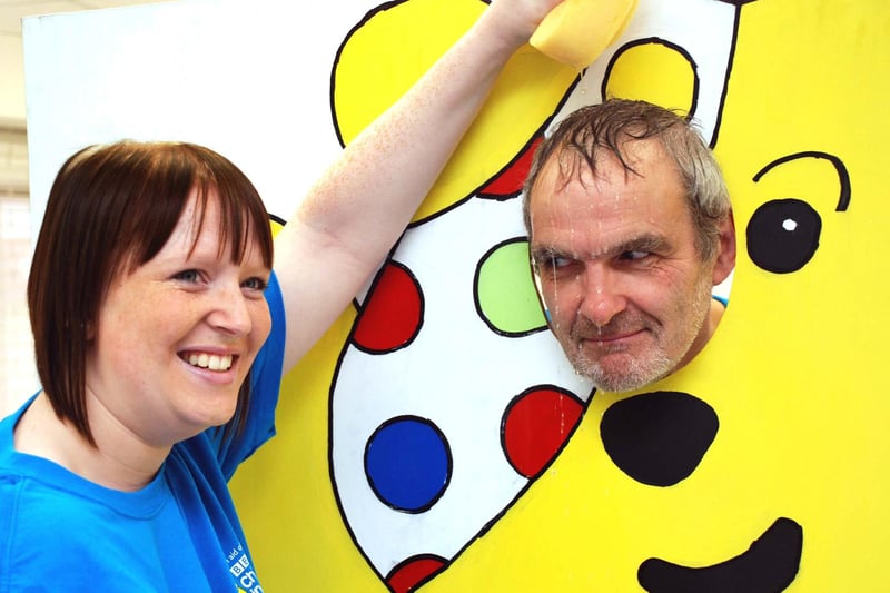 Peter Gregory, manager of Boots in Sutton gets a soaking by a member of staff, Hannah Walton in aid of Children in Need.