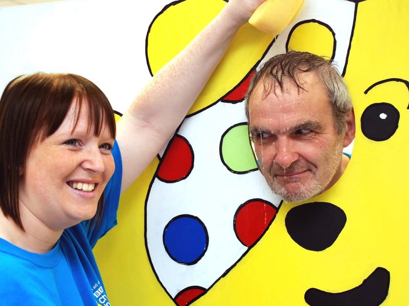 Peter Gregory, manager of Boots in Sutton gets a soaking by a member of staff, Hannah Walton in aid of Children in Need.