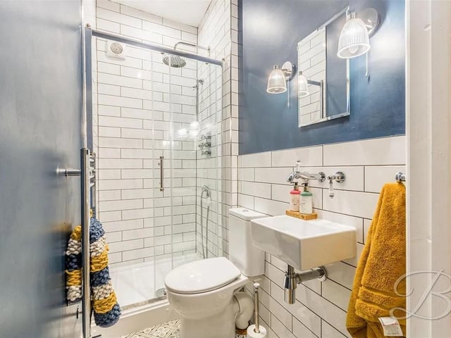 Three piece suite including a hand wash basin, low flush WC and a shower.