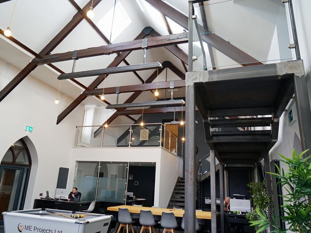 The traditional church beams remain, presenting a postmodern space for workers.