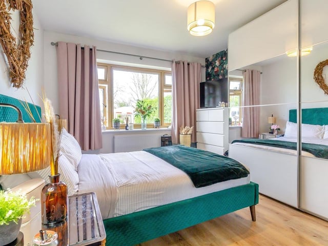 The second bedroom, which also faces the front of the property, is spacious and attractive. It has fitted wardrobes, with hanging rails, shelving, lighting and sliding, mirrored front doors.