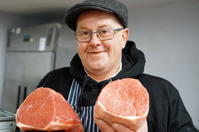 Butcher Ian Gillard holding salmon cut roasting beef.