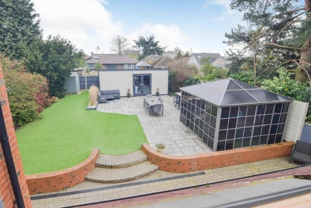This aerial shot gives a good view of the landscaped back garden, with its patio and artificial lawn. The two buildings are the 'pub shed' and the fitted gazebo.