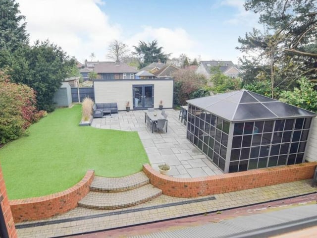This aerial shot gives a good view of the landscaped back garden, with its patio and artificial lawn. The two buildings are the 'pub shed' and the fitted gazebo.