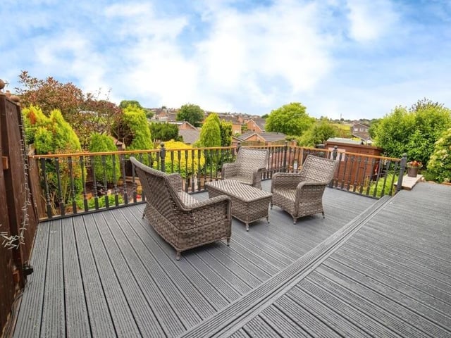 This is the upper level of the rear garden -- a splendid raised and decked seating area. offering a chance to relax and unwind while taking in the views.