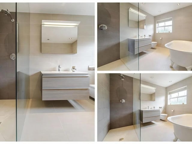 One of the en suites featuring a freestanding claw-foot bath, a walk-in shower, low flush WC, and hand wash basin, all complemented by a window to the rear elevation for natural light.