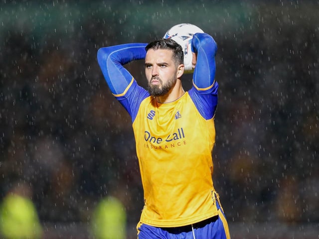 Stephen McLaughlin takes a throw as the rain teems down.