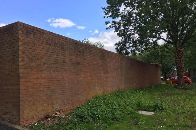 Residents reported incidents of anti-social behaviour taking place behind the high wall.