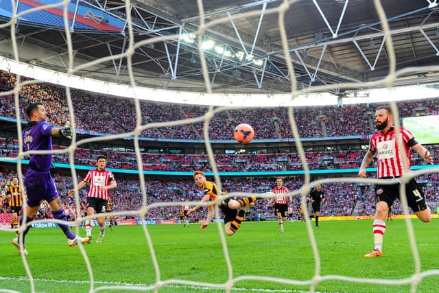 Stephen Quinn of Hull City heads in their fourth goal during the FA Cup semi-final match against Sheffield United at Wembley Stadium on April 13, 2014.