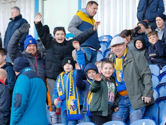 Mansfield Town fans watch the match against Northampton Town.