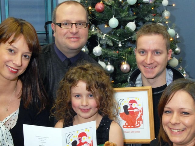 Mia Pidcock was presented with her framed Christmas card which was picked out by Ashfield MP Gloria De Piero for her constituency office, she is pictured with then Chad News Editor Ashley Booker and her parents Mark Pidcock, second right and mum Janet Zarebski, right.