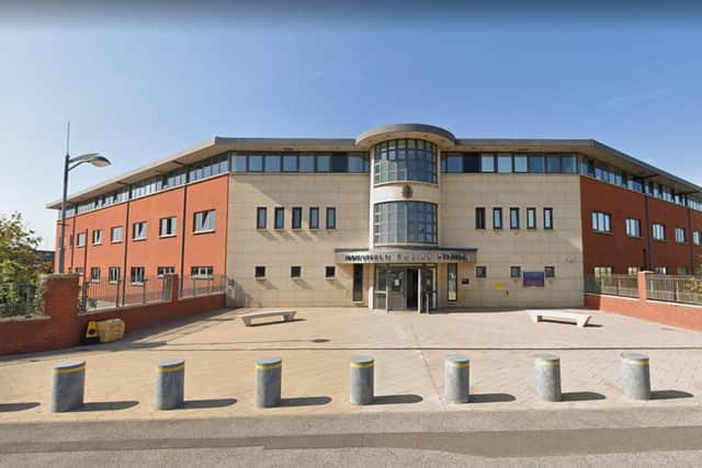 A woman has been arrested after trying to steal a dog outside a Mansfield Police Station.