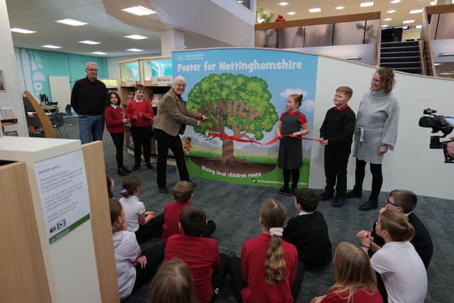 Nottinghamshire Council's cabinet member for children and families, Coun Tracey Taylor, and pupils from Sutton Road Primary and Nursery School cut the ribbon to unveil the family tree in Mansfield Library.