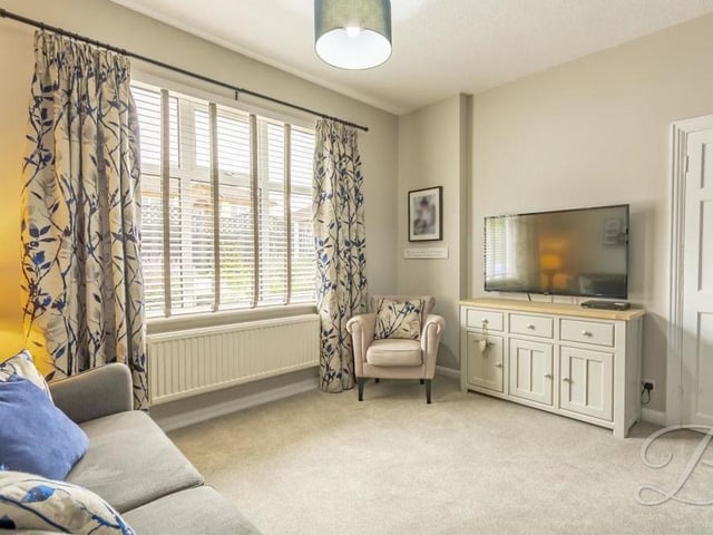 The bright and cheerful living room at the Budby Avenue bungalow from a different angle. Natural light floods through the window, which overlooks the front of the property.