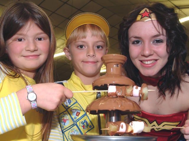 Members of 1st Mansfield Woodhouse Brownies held a Children In Need fundraising event. Pictured from the left are; brownies Amy Thacker 9 and Bethany Newton and Wonder Woman Lizzie Sale. 2006.