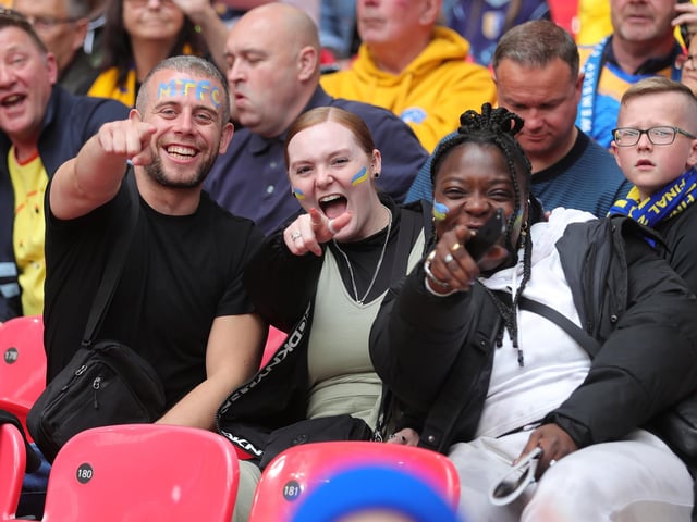 Mansfield Town fans watch the drama unfold inside Wembley.