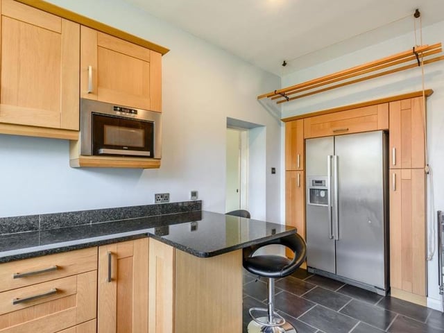 A final view of the breakfast kitchen, where there is space for an American fridge/freezer. It also features an integrated dishwasher and microwave.