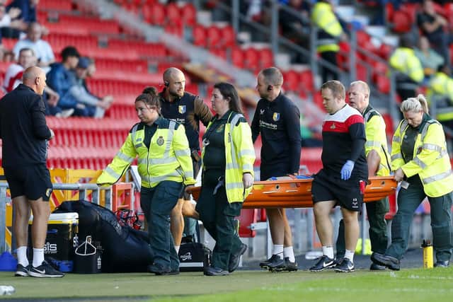 Mansfield Town defender Alfie Kilgour is stretchered off during the Sky Bet League 2 match against Doncaster Rovers FC at the Eco-Power Stadium  
Photo Chris & Jeanette Holloway / The Bigger Picture.media