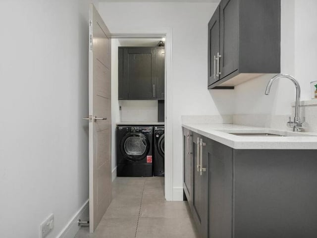 Just off the kitchen is a two-part utility room.The first includes wall cupboards, base units and an inset sink with drainer and chrome mixer tap. The second has matching wall cupboards and work surfaces, with plumbing for a washing machine and space for a tumble dryer.