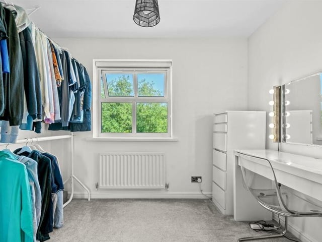 One of the upstairs bedrooms is currently being used as a dressing area, attached to the primary bedroom. But like so many spaces of the house, it is flexible and could be put to multiple uses, including as a nursery.