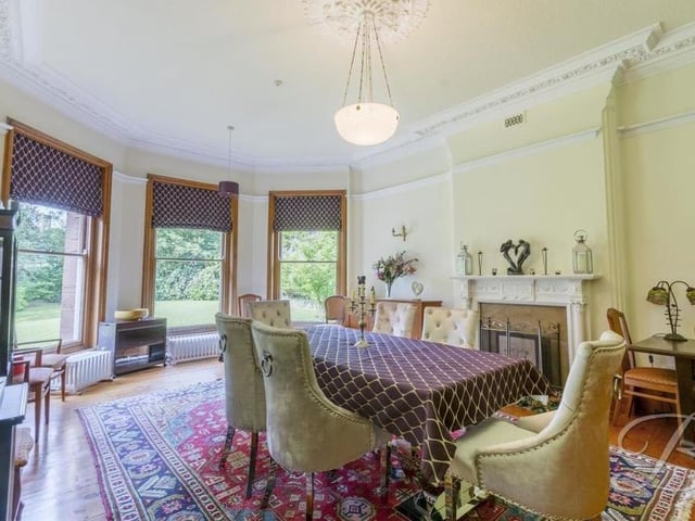The dining room at the Mansfield mansion is the epitome of elegance. A fireplace, coving and wooden-plank flooring are all notable features, while three tremendous bay windows face the side of the house and propel lots of natural light into the room.