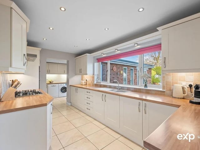 The stylish kitchen is beautifully appointed with a range of base cupboards and banks of wall cabinets along with an elegant display cabinet and units offering plenty of storage. Quality appliances include Neff double oven, Neff five ring gas hob with Neff extractor above, and there is an integral fridge.
