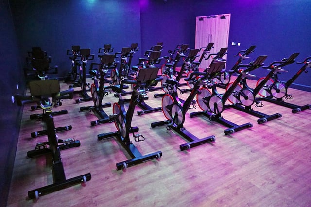 A room is all set up for a spin class.
