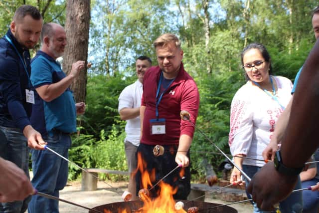 Amazon employees roasting marshmallows in the Woodland Adventure Zone at Portland Charity. (Photo by: Portland Charity)