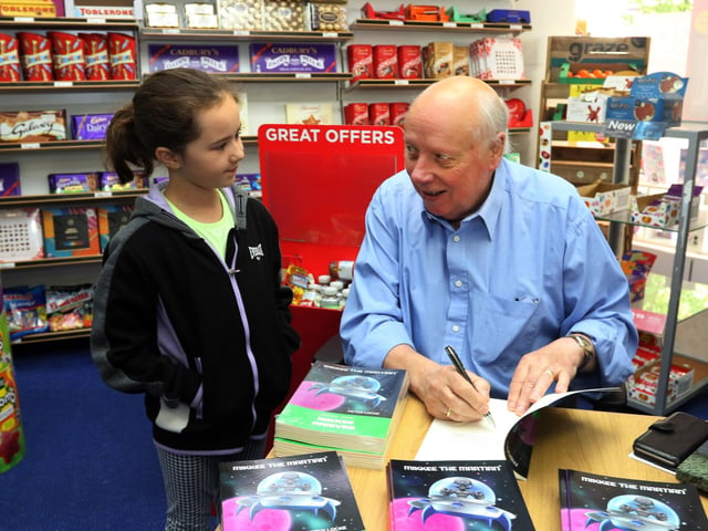 Author Peter Locke signs a book for Samantha May Morris in 2019.