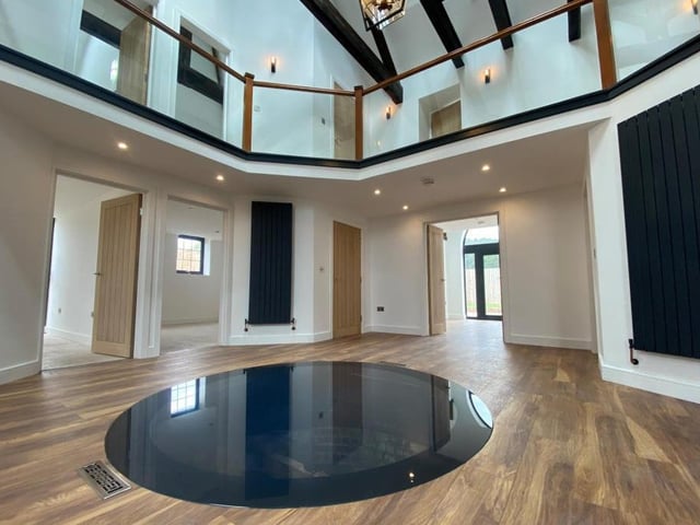 See how the glass window overlooking the old well dominates the entrance atrium. A truly unique feature of a unique property.