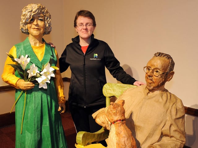 Mansfield Museum's Jodie Henshaw with a model of the artist Phillip Cox, who forms part of his papier mache sculpture exhibition with a model of his wife at the Leeming Street museum.